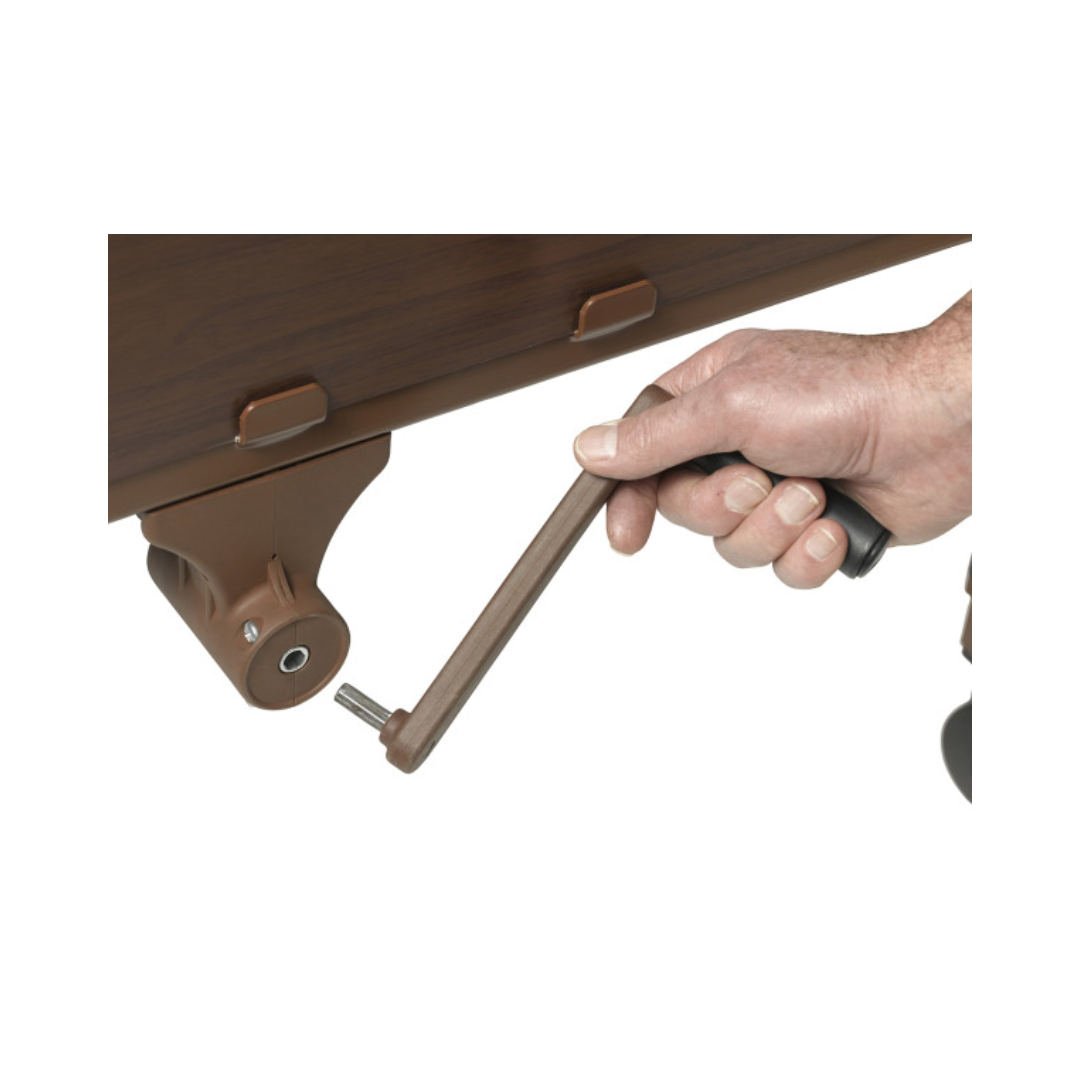 Hand turning the crank handle on a brown wood competitor II semi electric hospital bed by Drive Medical