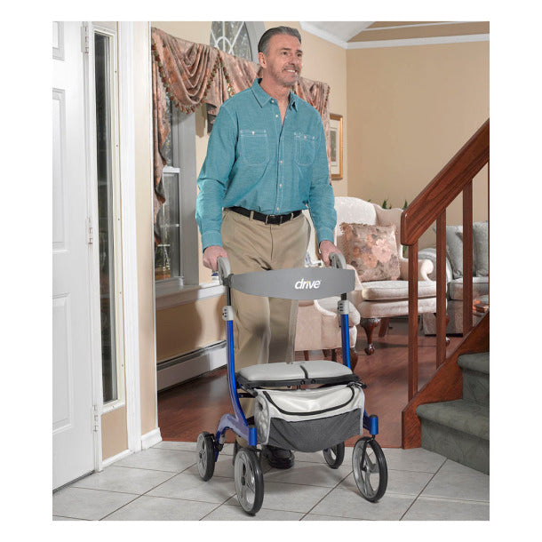 Man using Drive Medical Nitro DLX Euro Style Rollator indoors for mobility assistance
