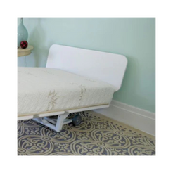 White minimalist headboard attached to adjustable bed frame in bedroom with patterned rug