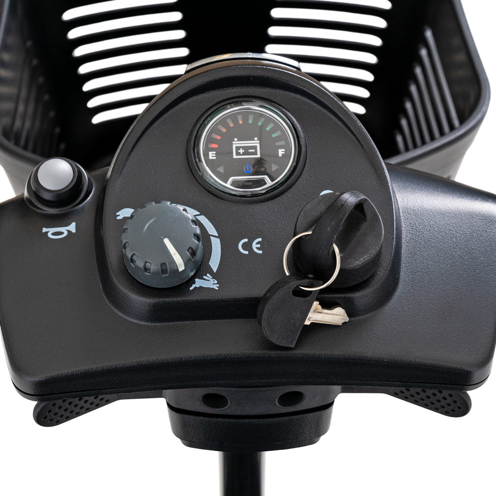 Control panel close-up of Pride Mobility Go Go Ultra X 3-Wheel Mobility Scooter with battery gauge and key