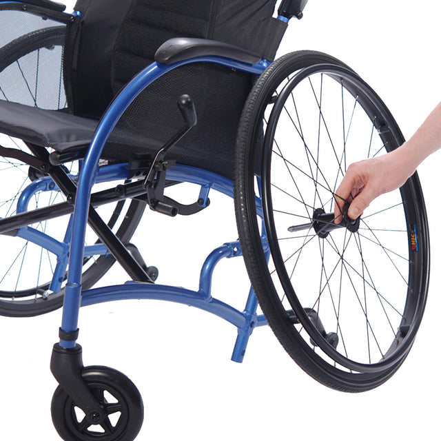 Close-up of blue STRONGBACK 24AB Transport Wheelchair 1007AB with hand adjusting rear wheel quick release