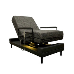 Adjustable reclining chair style bed with remote control and black textured upholstery THE INDEPENDENCE BED