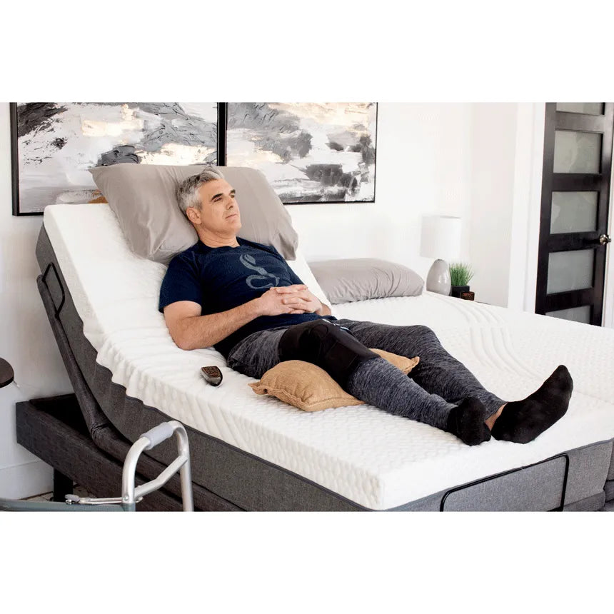Golden Technologies Passport Hi Low Adjustable Bed in Gray with a Man Reclining Comfortably