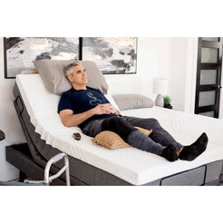 Golden Technologies Passport Hi Low Adjustable Bed in Gray with a Man Reclining Comfortably