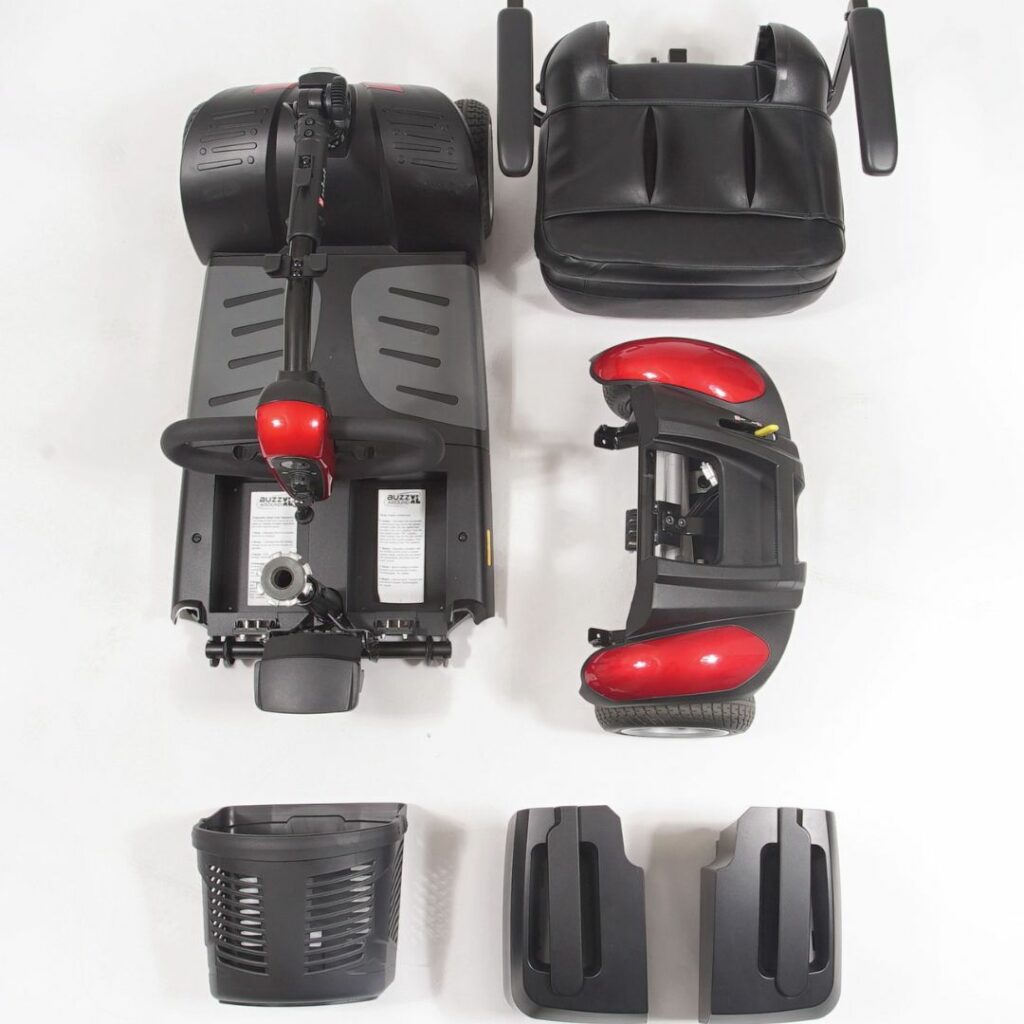 Buzzaround EX Extreme 4 Wheel Mobility Scooter disassembled showing seat, basket, and base components