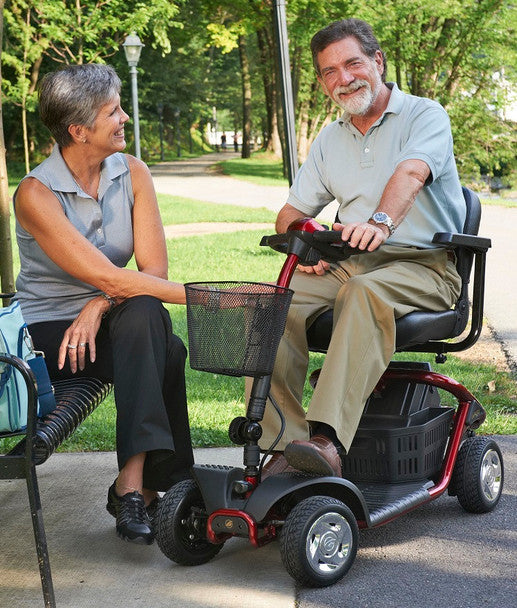 Golden Technologies LiteRider 4 Wheel Mobility Scooter in red, parked with a user on a path