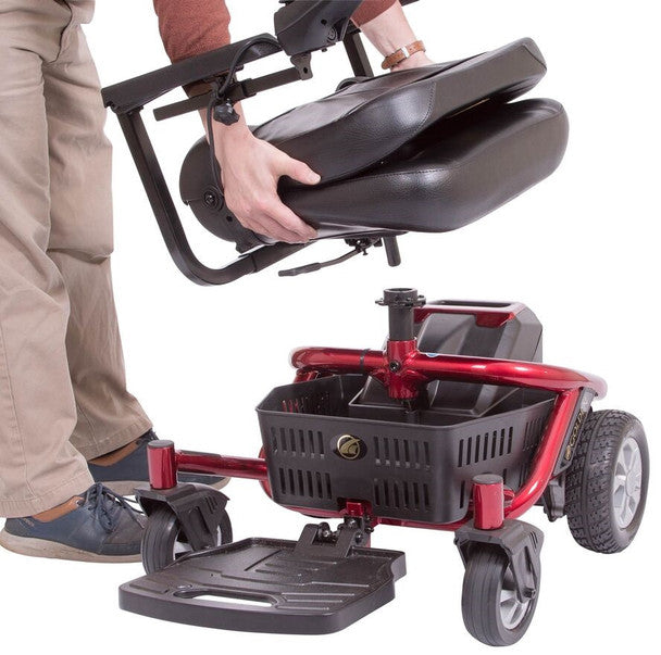 Golden Technologies LiteRider Envy folding mobility scooter in red being lifted for easy storage