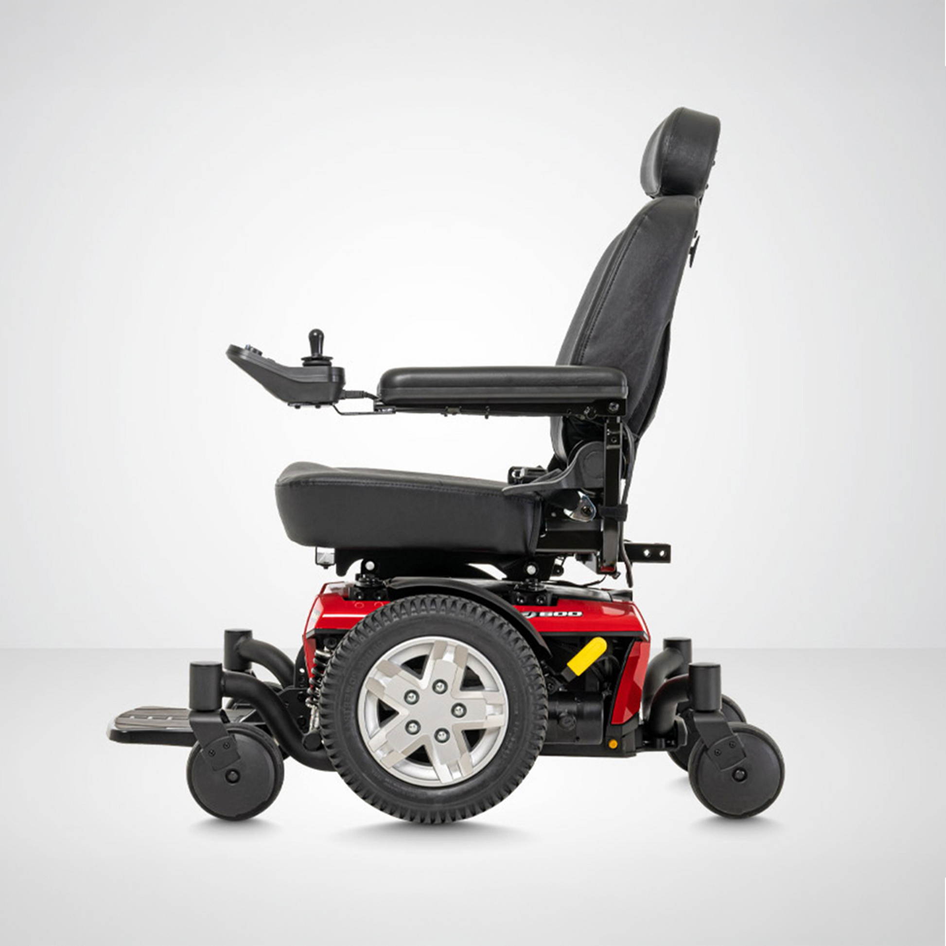 Side view of Pride Jazzy 600 ES Power Chair featuring black padded seat and red base with control joystick