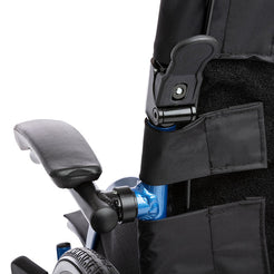 Close up of STRONGBACK 24 Flip Wheelchair 1019 padded flip back armrest with folding latch and backrest pocket and rear wheel