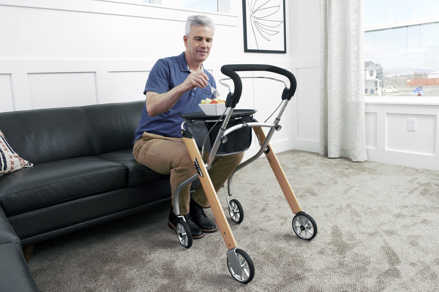 Man using Trust Care Lets Go Indoor Rollator Walker with wooden frame and black handle indoors