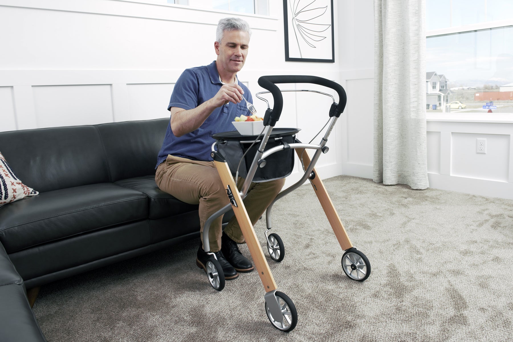 Man using Trust Care Lets Go Indoor Rollator Walker with wooden frame and black handle indoors