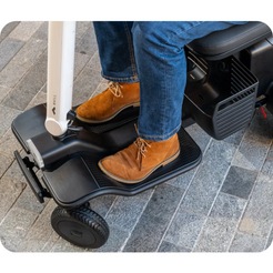 Whill Model R Urban 4 Wheel Mobility Scooter in black with person riding