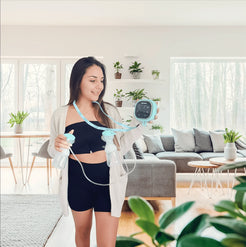 Zomee Z2 Double Electric Breast Pump with dual pumps for efficient milk expression in a cozy home setting