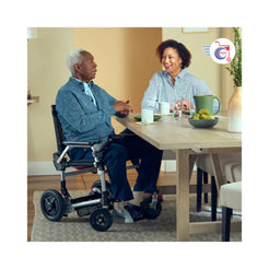 Journey Health & Lifestyle Zoomer Electric Power Mobility Folding Chair in use at a dining table